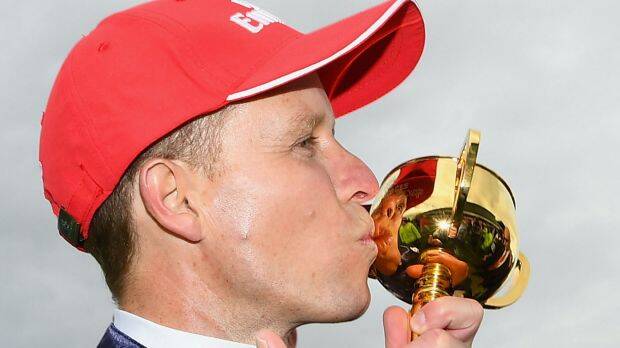 CHAMPION: Kerrin McEvoy, who rode Almandin, kisses the Melbourne Cup after winning. Photo: Getty Images