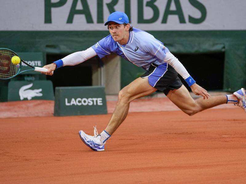 Alex de Minaur produced a virtuoso display on wet clay to power into the French Open second round. (AP PHOTO)