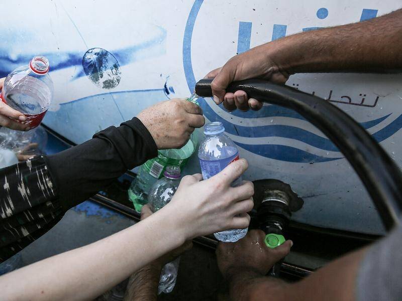 Gaza Strip civilians are desperate for water, as Israel cuts off supplies. (EPA PHOTO)
